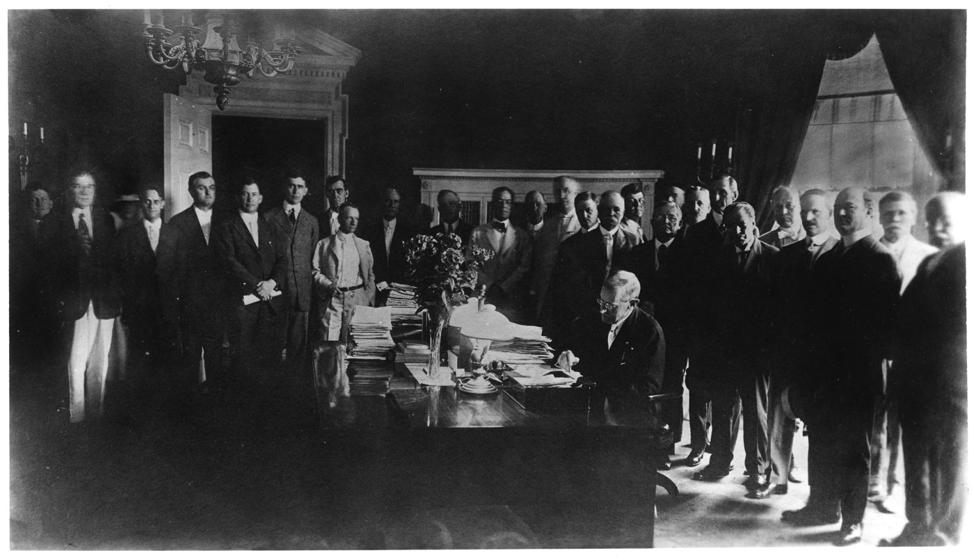 Archival photograph: President Wilson signs the Federal Farm Loan Act of 1916.