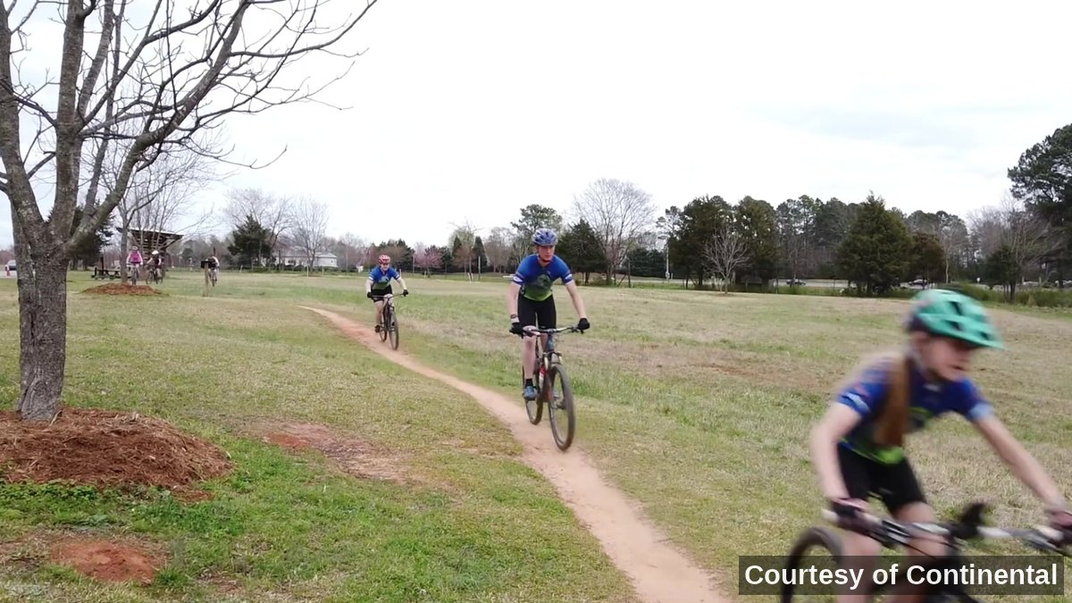 NICA GRiT riders moving along a trail.